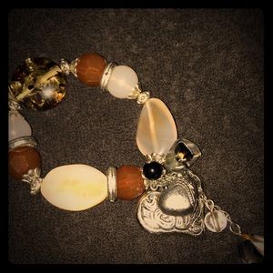 Beautiful earth tone bracelet with heart charm.